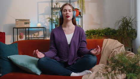 woman breathes deeply eyes closed, meditating with concentrated thoughts, peaceful mind at home