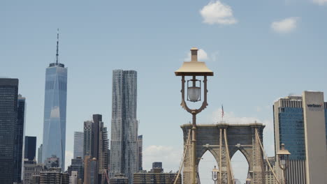 The-One-World-Trade-Center-and-the-Brooklyn-Bridge-at-a-sunny-day-with-a-blue-sky,-static-shot