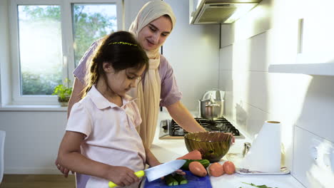 Vista-Lateral-De-Madre-Con-Hiyab-E-Hija-En-La-Cocina.