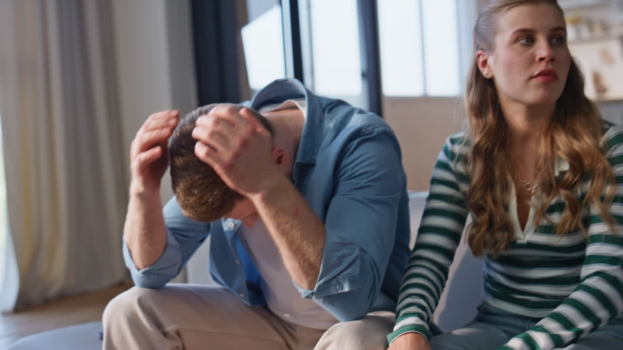 Excited couple watching football game on TV at home closeup. Emotional woman man