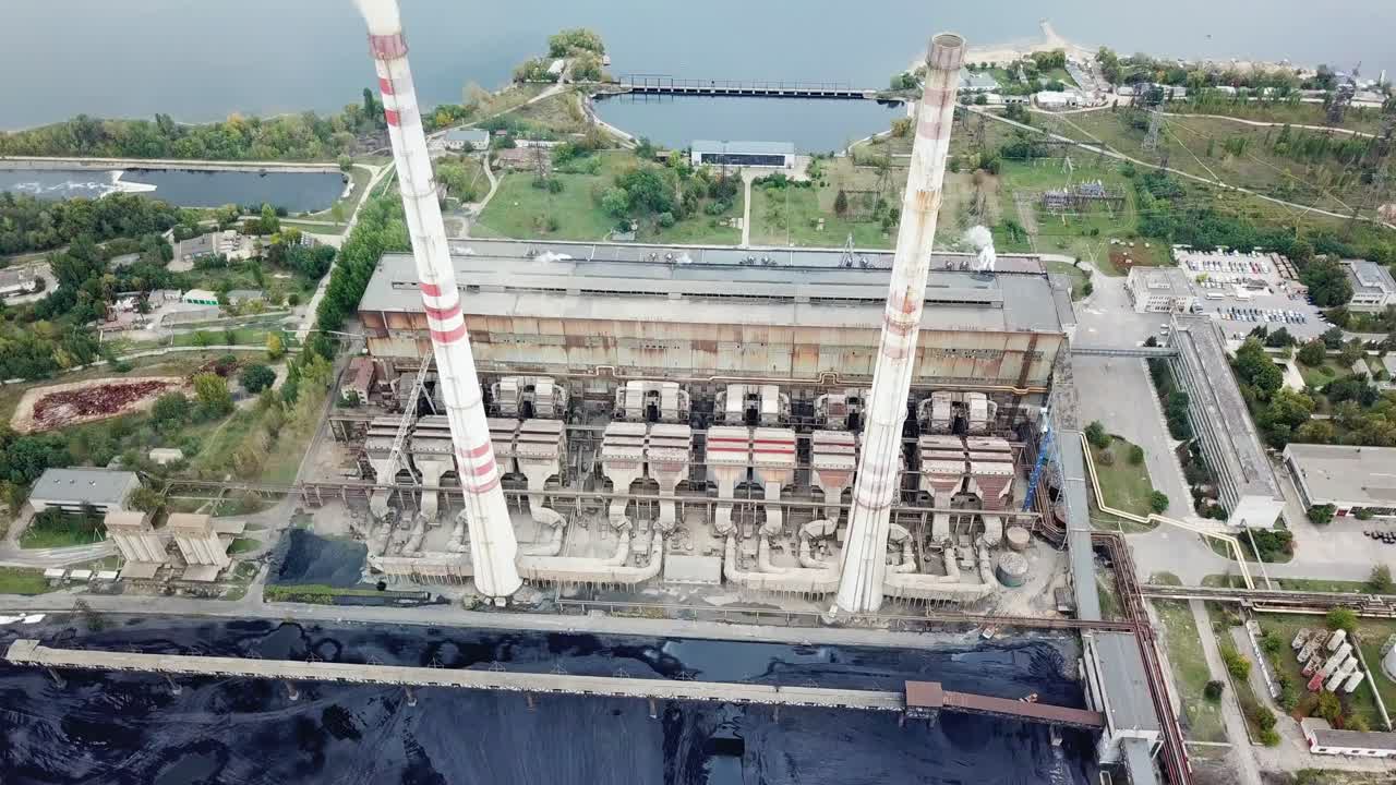 Smoking industrial pipes. Air pollution by smoke coming out of two factory chimneys