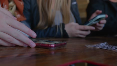 Close-up-shot-of-two-females-interacting-on-their-cell-phones