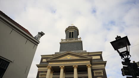 tiro de lapso de tiempo de la hermosa y antigua catedral católica hartebrugkerk en leiden durante el día nublado