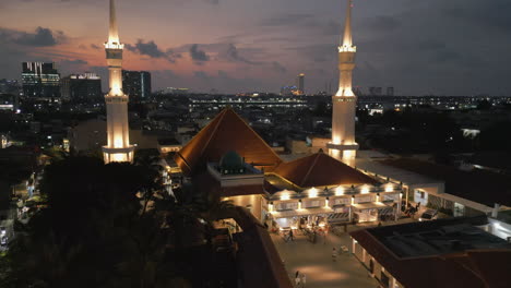aerial view of a mosque at sunset in a city