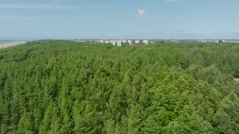 Aerial-establishing-view-of-crowded-residential-district-apartment-buildings-on-a-sunny-summer-day,-renovated-and-insulated-houses,-colorful-walls-of-the-facade,-green-trees,-drone-shot-moving-forward