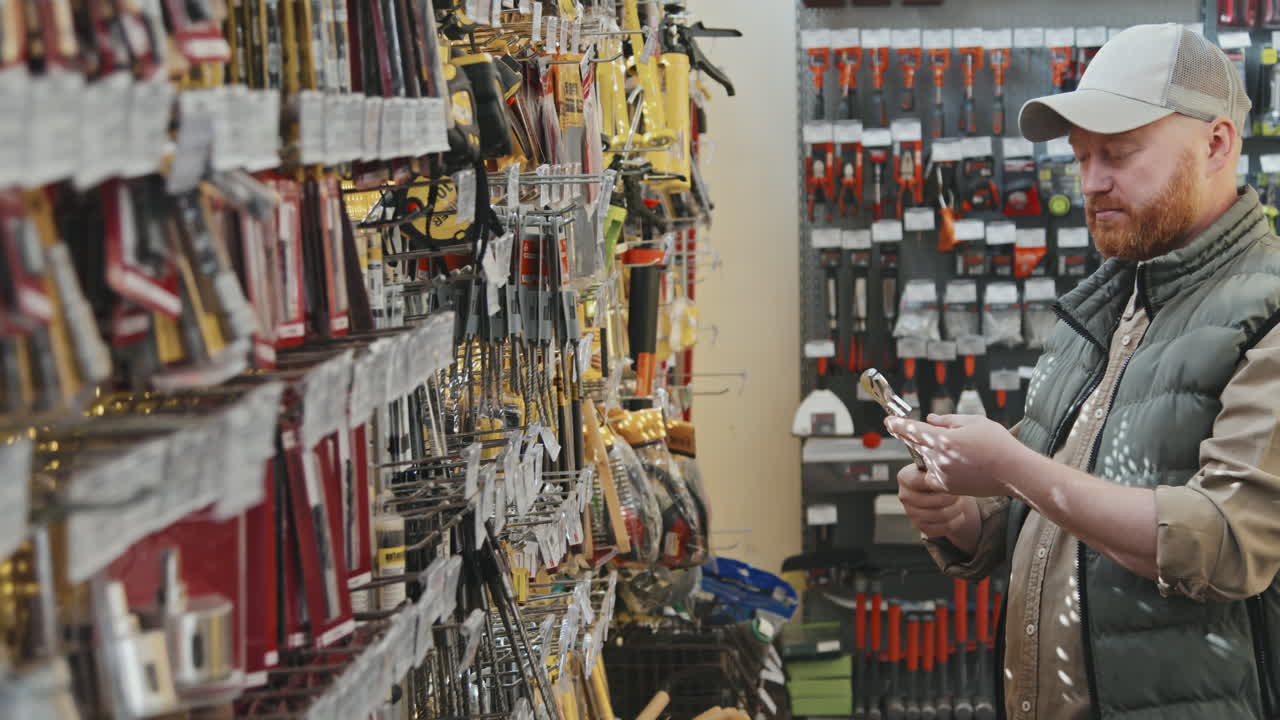 Guy Choosing Tool at Hardware Store