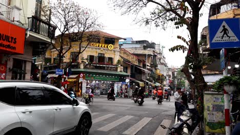 street scene with motorbikes and pedestrians