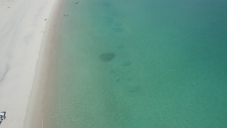bird's eye view over turquoise seascape of great keppel island in australia - drone shot