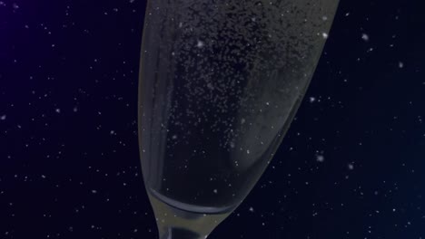 Animation-of-falling-confetti-over-glass-of-champagne-on-dark-background