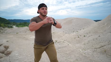 man doing squats in a quarry
