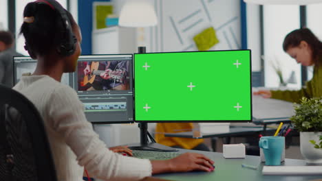 black videographer using computer with chroma key