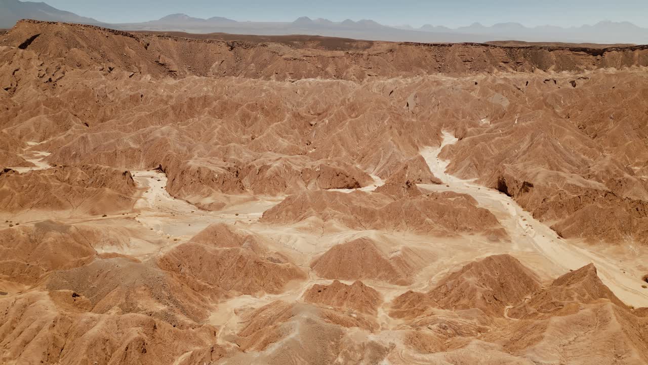 Explore Atacama's moon-like landscape with stunning drone footage capturing the rugged rock formations and endless horizon of the desert