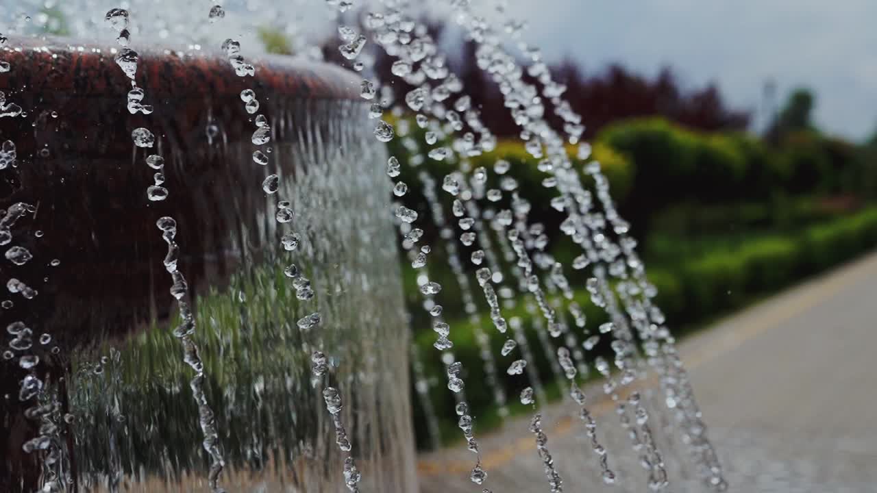 Splashing water fountain. Detail of classic style stone fountain with flowing water
