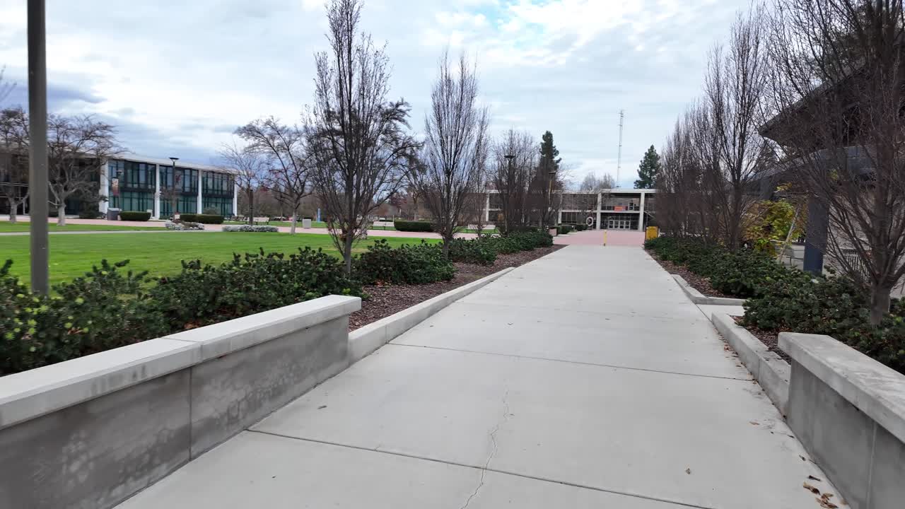 A POV stroll across the Stanislaus State campus showcases trees, lecture halls, and pedestrian paths, offering a natural sense of scale and movement through this Central Valley college setting