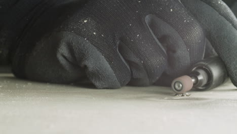 electric milling cutter with a sandpaper tip flattens a screw into the wood