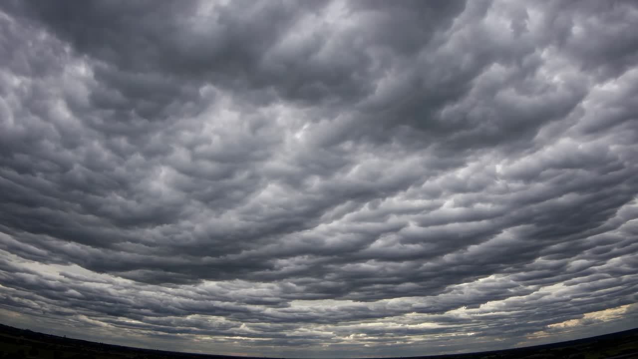 Dramatic fisheye view of a cloudy sky, capturing textured clouds in a wide-angle shot
