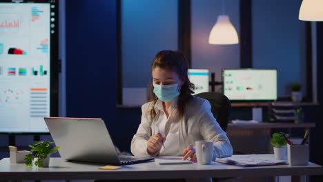 Manager-with-face-mask-working-overtime-in-new-normal-business