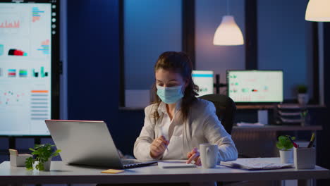 manager with face mask working overtime in new normal business