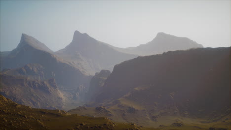 silhouette-of-swiss-alps-mountains-in-morning-clouds