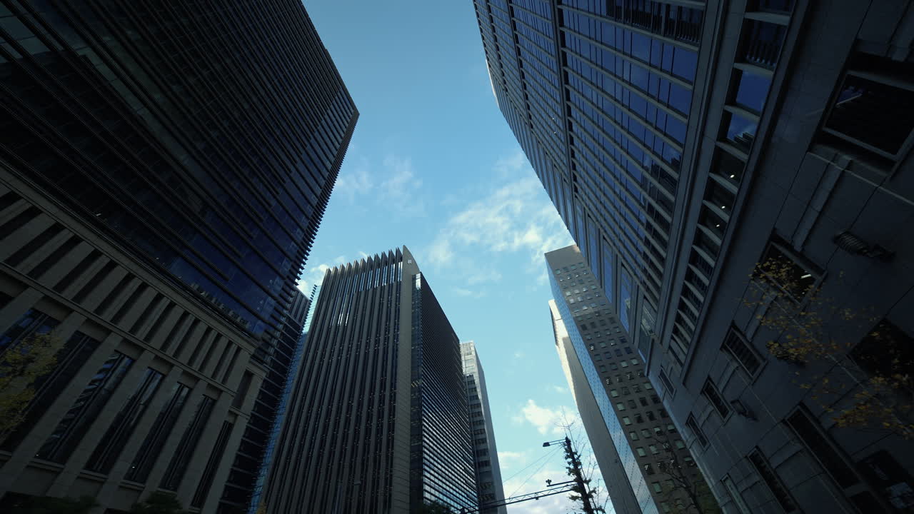 Tomada de ângulo baixo de edifícios comerciais modernos em Tóquio sob um céu limpo