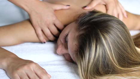 young woman getting a massage in a spa