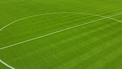 close-up, low-angle aerial view of a portion of a lush green soccer field