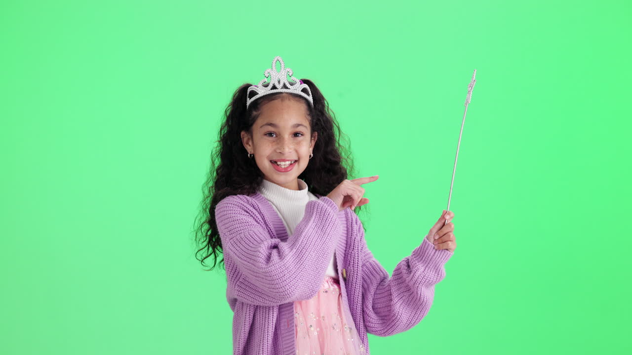 Girl dressed as a princess with a magic wand on a green screen