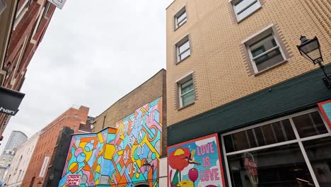 colorful mural with people passing by