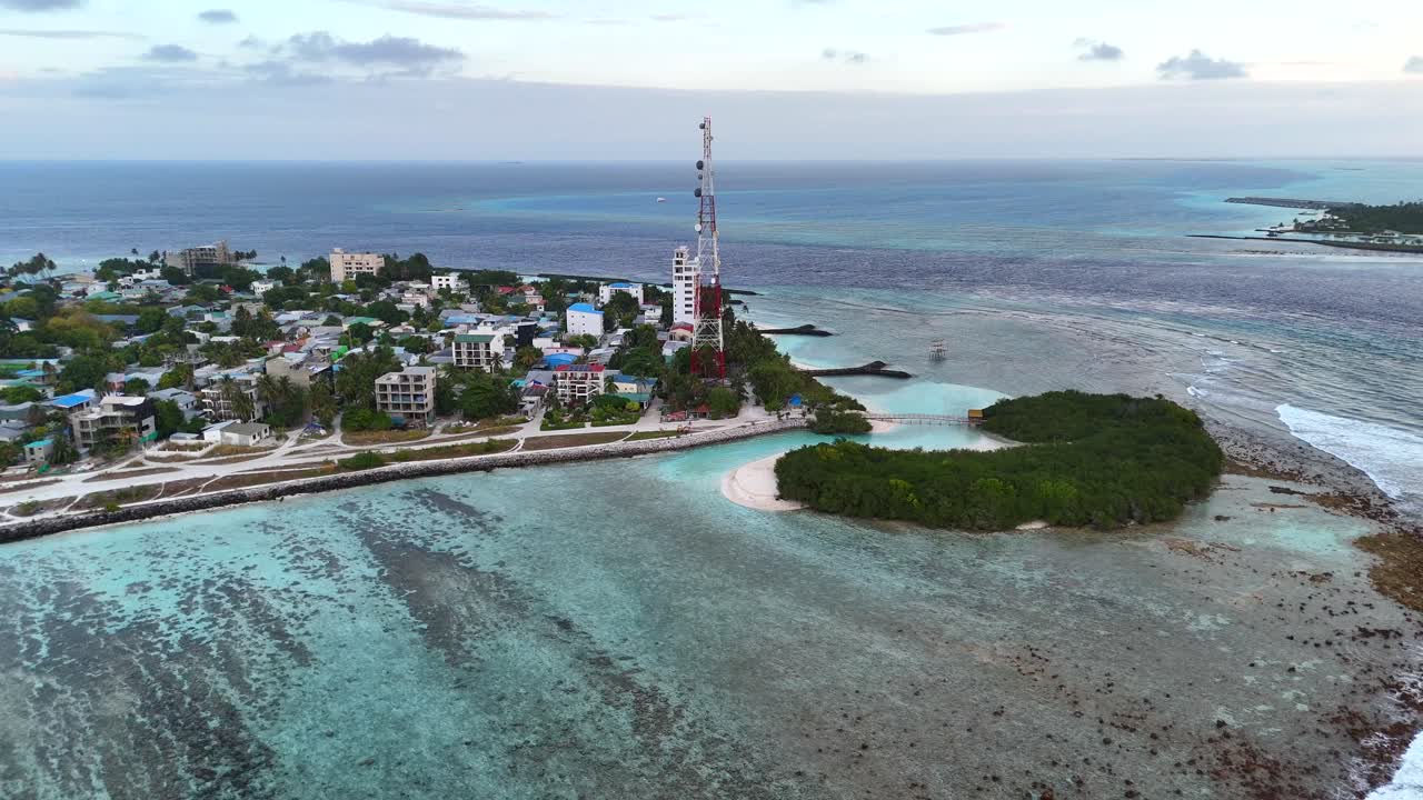 Ripresa aerea con drone Thulusdhoo Maldive isola tropicale esotica remota barriera corallina sabbia bianca acqua turchese.