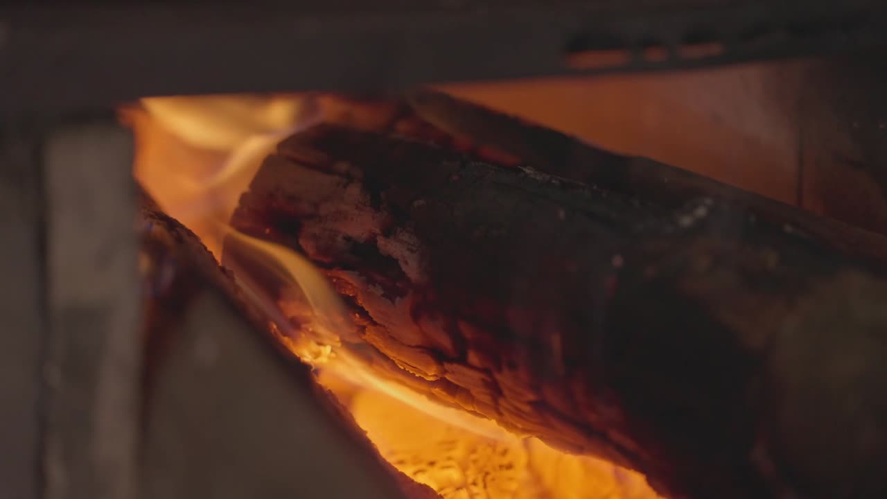 Un forno a legna usato per alimenti artigianali con legna da ardere che prende fuoco e brucia.