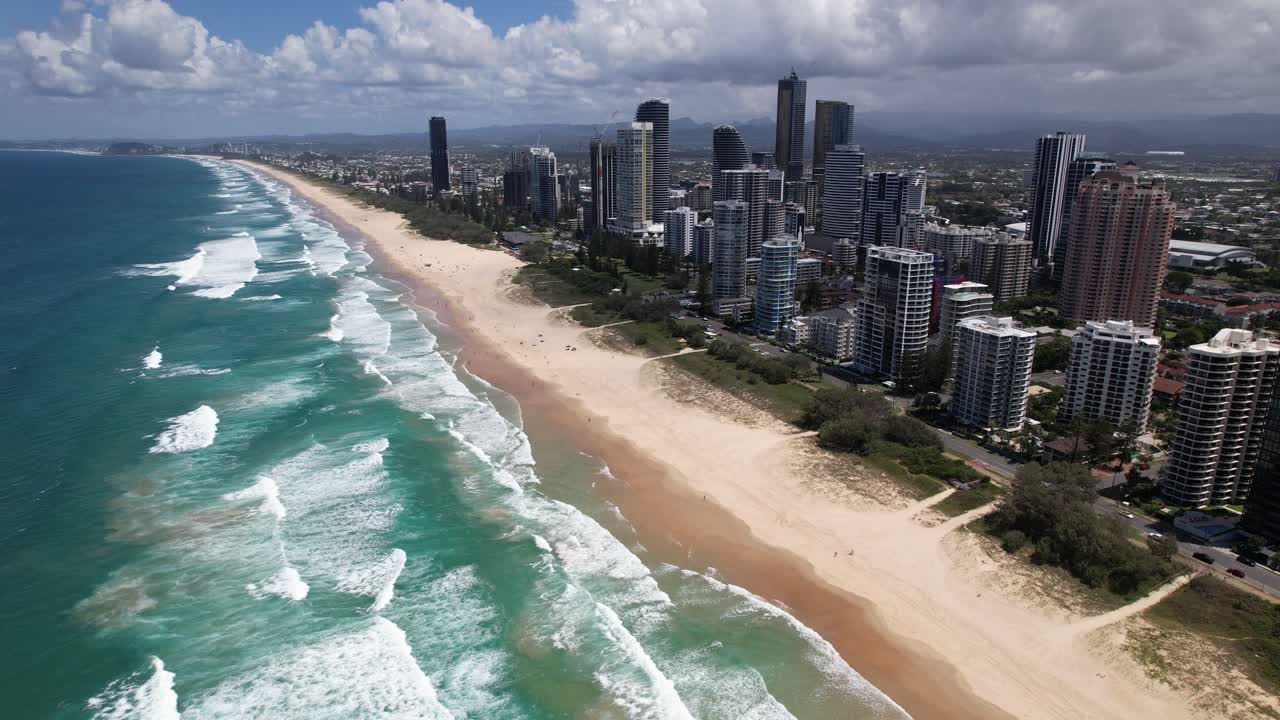 Golden Sands Meet Turquoise Waves Alongside the Jewel Residences and The Langham, Set Against a Skyline Near Broadbeach in Gold Coast, Queensland, Australia - Aerial Drone Shot