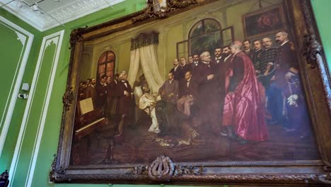 painting of a historical event with a group of people indoors.