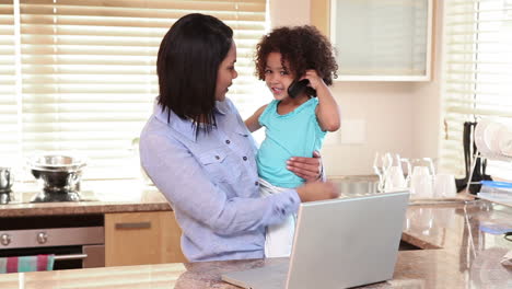 Mother-handing-a-phone-to-her-daughter