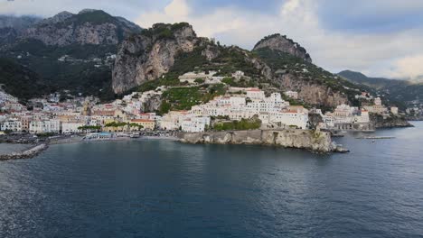 Aerial-View-of-Scenic-Amalfi-Hillside-City-on-Italian-Coast-of-Mediterranean-Sea-on-Summer-Evening