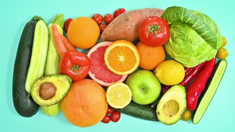 cyan background full with fresh ripe and organic fruits and vegetables appear. stop motion flat lay