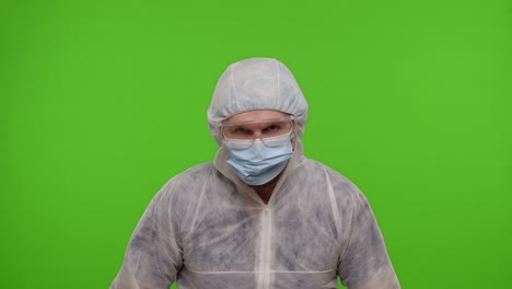 crazy doctor in ppe protective suit with two syringes dancing, fooling around, making silly faces