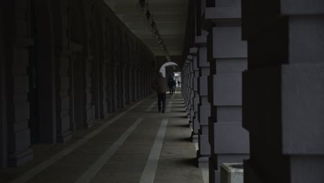 old-man-walking-down-an-alley-during-the-first-hours-of-morning,-in-the-center-of-dimitrovgrad,-bulgaria