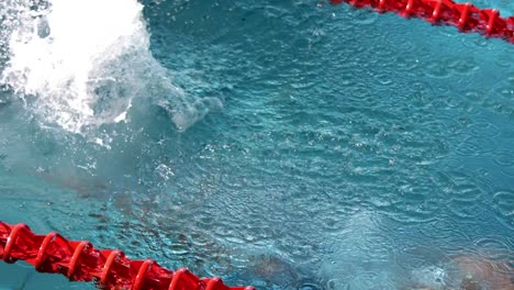 fit man diving into pool