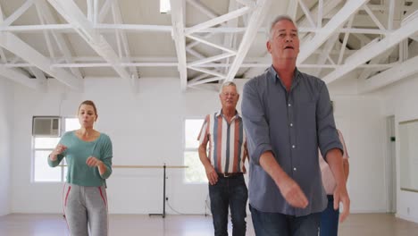 senior-male-and-female-friends-spending-time-together-in-a-ballroom-and-dancing