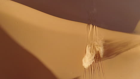 Top-down-view-of-riding-motocross-bike-on-sand-dunes-in-Merzouga-desert,-Morocco