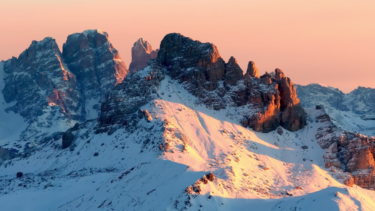 Aerial drone view of snow on the mountains in the Dolomites, Italy at sunset