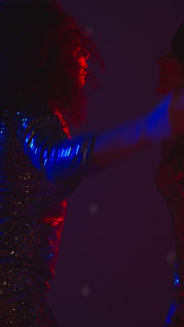 Vertical-Video-Of-Two-Women-In-Nightclub-Bar-Or-Disco-Dancing-With-Sparkling-Lights-In-Background-2