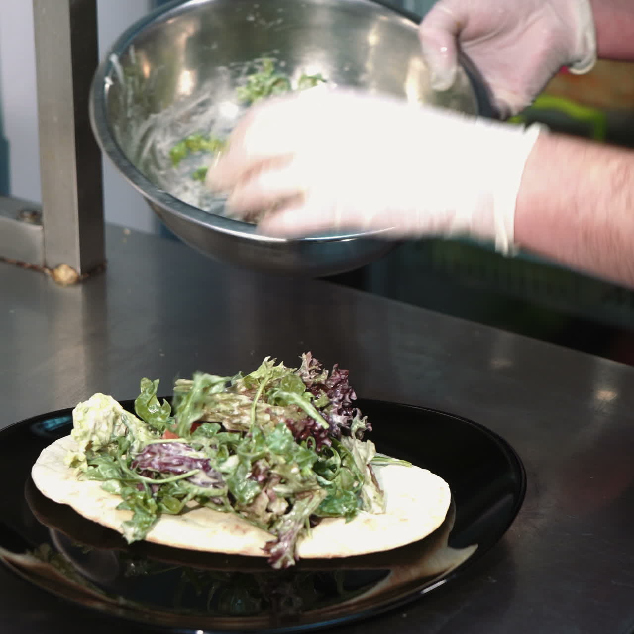 Chef cooking salad in a professional kitchen in a restaurant. Hands close up Sqare video