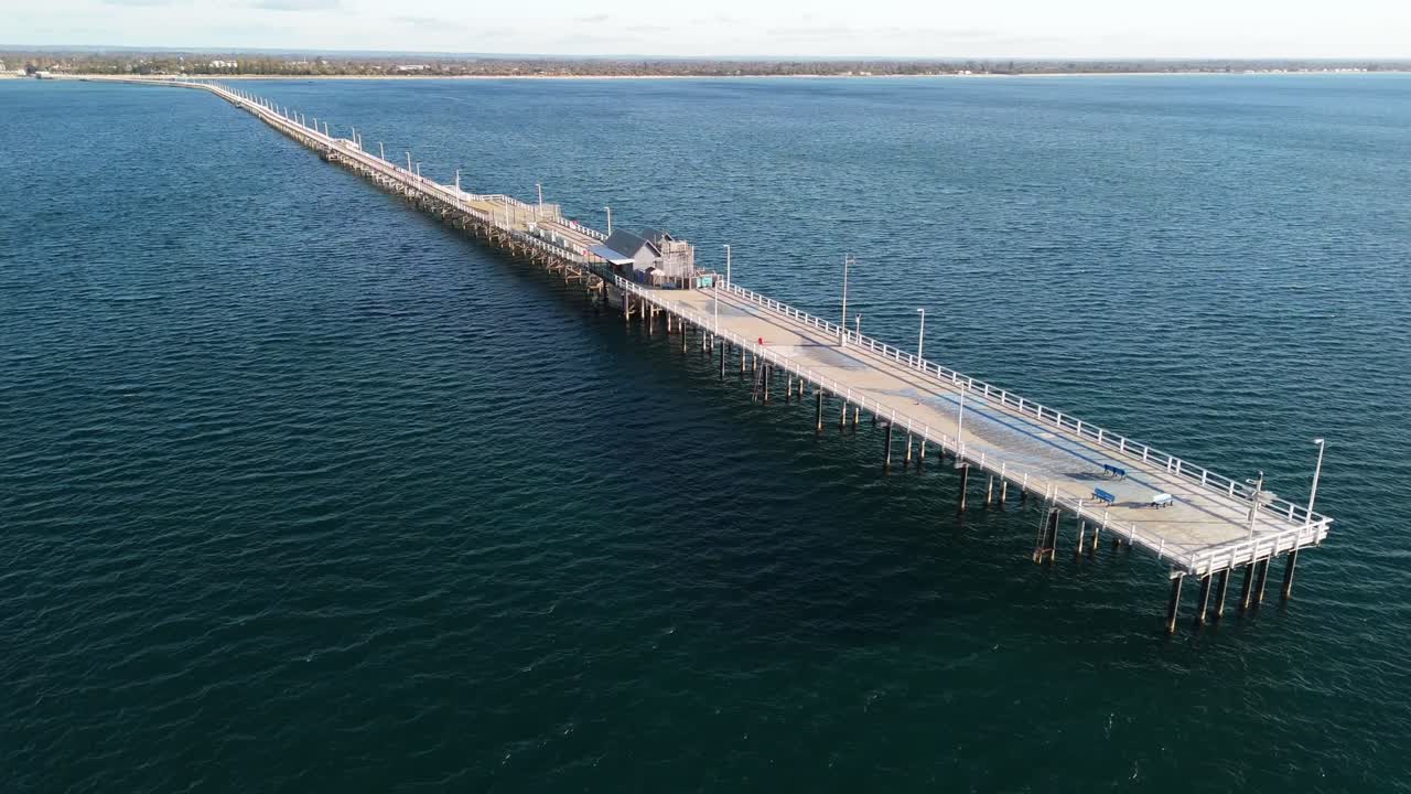 Aerial View of a Long Pier Extending into the Ocean
