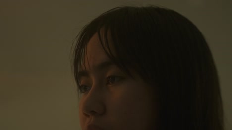a woman's face, pale and strained, carries a distant expression, reflecting signs of a mental health struggle - close up