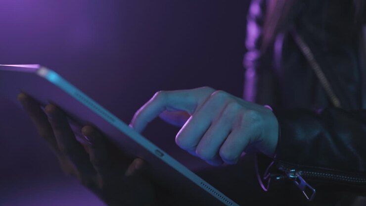 Unrecognizable woman in VR glasses browsing tablet
