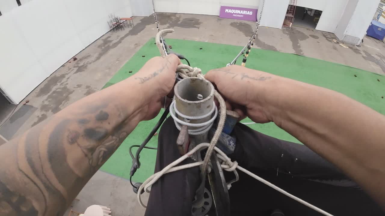 POV Shot of Worker's Hands Tying Rope for Event Setup