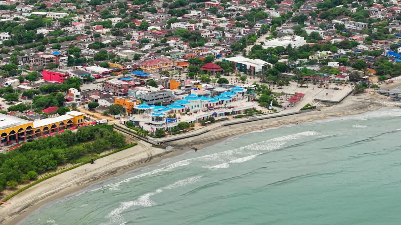 Drone footage showcasing the coastline, buildings, and caribbean sea in puerto colombia, atlantico