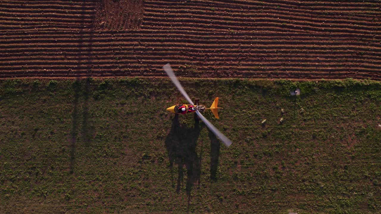 Ginosa’s gyrocopter at sunset, taking off from meadow, scenic beauty