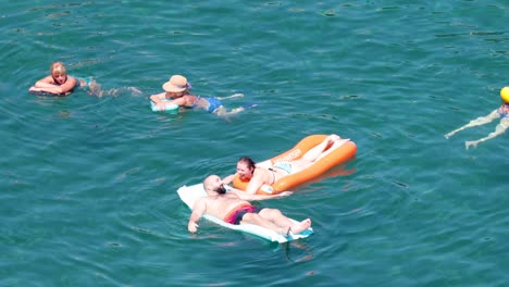 couple enjoying water on inflatable mat